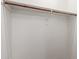 A empty walk in closet with white walls and a hanging rod at 9 S 195Th Ln, Buckeye, AZ 85326