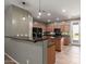 Kitchen featuring a breakfast bar, wood cabinets, and stainless steel appliances at 9 S 195Th Ln, Buckeye, AZ 85326