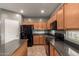 Well-equipped kitchen with wood cabinets, granite countertops, and modern appliances at 9 S 195Th Ln, Buckeye, AZ 85326