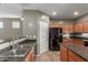 Kitchen with stainless sink, ample cabinetry and sleek black appliances at 9 S 195Th Ln, Buckeye, AZ 85326