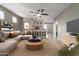 A spacious living room with modern decor seamlessly connects to an open-concept kitchen at 9 S 195Th Ln, Buckeye, AZ 85326