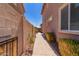 Walkway on side of home with desert landscaping and block wall fencing at 9 S 195Th Ln, Buckeye, AZ 85326