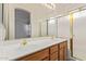 Bathroom featuring dual sinks and a shower with glass doors at 941 N Benson Ln, Chandler, AZ 85224