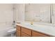 Well-lit bathroom featuring a shower-tub combo, vanity with a solid surface, and a large mirror at 941 N Benson Ln, Chandler, AZ 85224