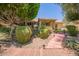 Inviting front entryway with mature trees, desert landscaping, and a brick path at 941 N Benson Ln, Chandler, AZ 85224