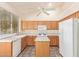 Charming kitchen with oak cabinetry, island, white appliances, and tile backsplash at 941 N Benson Ln, Chandler, AZ 85224
