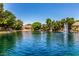 Scenic view of a lake with a fountain, surrounded by lush greenery and waterfront homes on a sunny day at 941 N Benson Ln, Chandler, AZ 85224