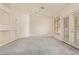 Bright living room with vaulted ceilings, a ceiling fan, built-in shelves, and French doors at 941 N Benson Ln, Chandler, AZ 85224