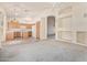 Spacious open concept living area with kitchen, ceiling fans, and neutral carpet at 941 N Benson Ln, Chandler, AZ 85224