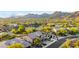 Expansive aerial view showcasing this desert home and community with mature trees and lush desert landscaping at 11124 N 138Th Way, Scottsdale, AZ 85259