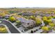 Expansive aerial view showcasing this desert home and community with mature trees and lush desert landscaping at 11124 N 138Th Way, Scottsdale, AZ 85259