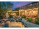 Backyard oasis with a pool, waterfall, and string lights at 11124 N 138Th Way, Scottsdale, AZ 85259