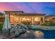 Entertainer's backyard with a pool, waterfall, and covered patio at 11124 N 138Th Way, Scottsdale, AZ 85259