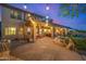 An outdoor living space featuring a stone patio, spiral staircase, fire pit and a built in barbecue at 11124 N 138Th Way, Scottsdale, AZ 85259