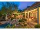 Desert backyard with a waterfall feature, string lights, and outdoor seating at 11124 N 138Th Way, Scottsdale, AZ 85259
