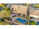 Aerial shot displaying a backyard oasis complete with pool, waterfall features, hot tub, covered patio, and desert landscaping at 11124 N 138Th Way, Scottsdale, AZ 85259
