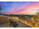 Picturesque balcony view with outdoor seating, city lights, and a vibrant, colorful sunset sky at 11124 N 138Th Way, Scottsdale, AZ 85259