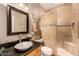 Bathroom featuring a frameless glass shower, vessel sink, and stone tiling at 11124 N 138Th Way, Scottsdale, AZ 85259
