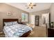Bedroom featuring a ceiling fan, carpet, and bright natural light from shuttered windows at 11124 N 138Th Way, Scottsdale, AZ 85259