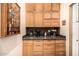 Coffee bar with granite countertop, wood cabinets, and mosaic tile backsplash at 11124 N 138Th Way, Scottsdale, AZ 85259