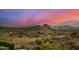 Scenic view showcasing desert landscape, mountain range, and the vibrant sunset sky at 11124 N 138Th Way, Scottsdale, AZ 85259