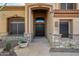 Close up of the front entrance with a stone-paved pathway, double door and stone pillars at 11124 N 138Th Way, Scottsdale, AZ 85259