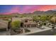 Aerial view of two-story home with desert landscaping, three-car garage and mountain views in the background at 11124 N 138Th Way, Scottsdale, AZ 85259