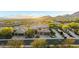 A stunning exterior view of a multi-story home in a beautiful desert community with mountain views at sunset at 11124 N 138Th Way, Scottsdale, AZ 85259