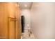 Hallway with wood cabinets and black refrigerator at 11124 N 138Th Way, Scottsdale, AZ 85259
