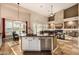 Bright kitchen with island sink, stainless steel appliances, and an adjacent dining area at 11124 N 138Th Way, Scottsdale, AZ 85259