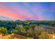 Expansive landscape view featuring desert vegetation, luxurious houses, and a colorful sky at dusk at 11124 N 138Th Way, Scottsdale, AZ 85259