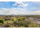 Scenic landscape view overlooking upscale houses, desert vegetation, and distant mountains under a blue sky at 11124 N 138Th Way, Scottsdale, AZ 85259