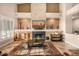 Open-concept living room with a fireplace, large windows, and a decorative rug at 11124 N 138Th Way, Scottsdale, AZ 85259