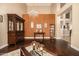 Formal living room with high ceilings, chandelier, dark hardwood flooring, and decorative furniture at 11124 N 138Th Way, Scottsdale, AZ 85259