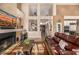 Spacious living room boasting high ceilings, a fireplace, and seamless flow to other rooms at 11124 N 138Th Way, Scottsdale, AZ 85259