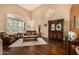 Bright living room with high ceilings, a large window, chandelier, and hardwood floors at 11124 N 138Th Way, Scottsdale, AZ 85259