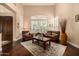 Bright living room with hardwood floors, shuttered windows, and comfortable leather seating at 11124 N 138Th Way, Scottsdale, AZ 85259