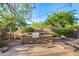 Outdoor kitchen with stone base and stainless steel grill, a fire pit and desert landscaping at 11124 N 138Th Way, Scottsdale, AZ 85259