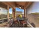 Outdoor patio features an elegant table and chairs, ceiling fan and retractable sunshades at 11124 N 138Th Way, Scottsdale, AZ 85259