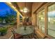 Cozy covered patio featuring outdoor seating, bistro lights, and a serene backyard view at 11124 N 138Th Way, Scottsdale, AZ 85259