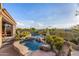Beautiful pool and hot tub with rock waterfall feature, surrounded by lush desert landscaping at 11124 N 138Th Way, Scottsdale, AZ 85259