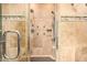 Modern shower with neutral colored tiles and built-in shower shelf at 11124 N 138Th Way, Scottsdale, AZ 85259