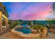 Outdoor spa with stone surround and desert landscape at 11124 N 138Th Way, Scottsdale, AZ 85259