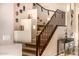 Carpeted staircase with wooden railing and unique decorative masks at 11124 N 138Th Way, Scottsdale, AZ 85259