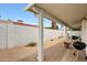 Covered patio area with bbq and a gravel yard, perfect for outdoor entertaining and relaxing at 1122 E Michelle Dr, Phoenix, AZ 85022