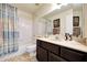 Well-lit bathroom featuring a shower-tub combo, single sink vanity, and neutral color scheme at 1122 E Michelle Dr, Phoenix, AZ 85022