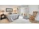 Relaxing bedroom with sliding doors leading to the outdoors and a comfortable rocking chair at 1122 E Michelle Dr, Phoenix, AZ 85022