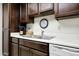 This kitchen includes dark wood cabinets, a stainless steel sink, and a white dishwasher at 1122 E Michelle Dr, Phoenix, AZ 85022