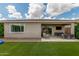 Lush backyard featuring artificial grass, covered patio, hanging chair, and built in grill at 12289 E Ballentine Rd, Gold Canyon, AZ 85118