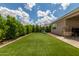 Open backyard with green artificial turf, wooden swing set, and plenty of space for outdoor enjoyment at 12289 E Ballentine Rd, Gold Canyon, AZ 85118